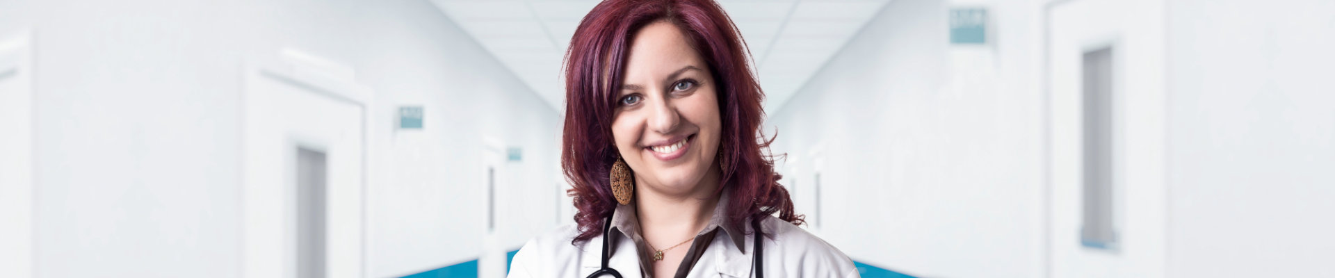 nurse with red hair smiling for the camera
